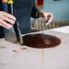 person checking the temperature of a chocolate icing