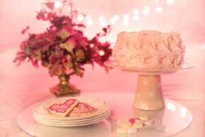 pink icing cake on cake stand