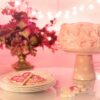 pink icing cake on cake stand