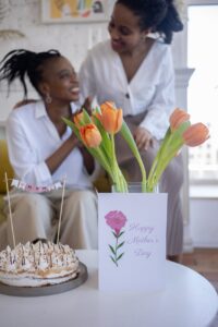 cake and tulips on white table