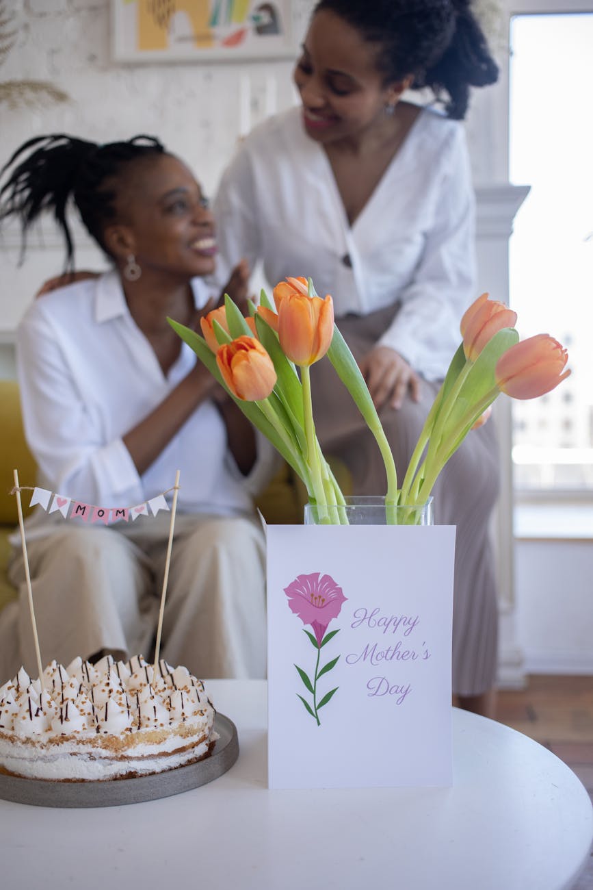 cake and tulips on white table